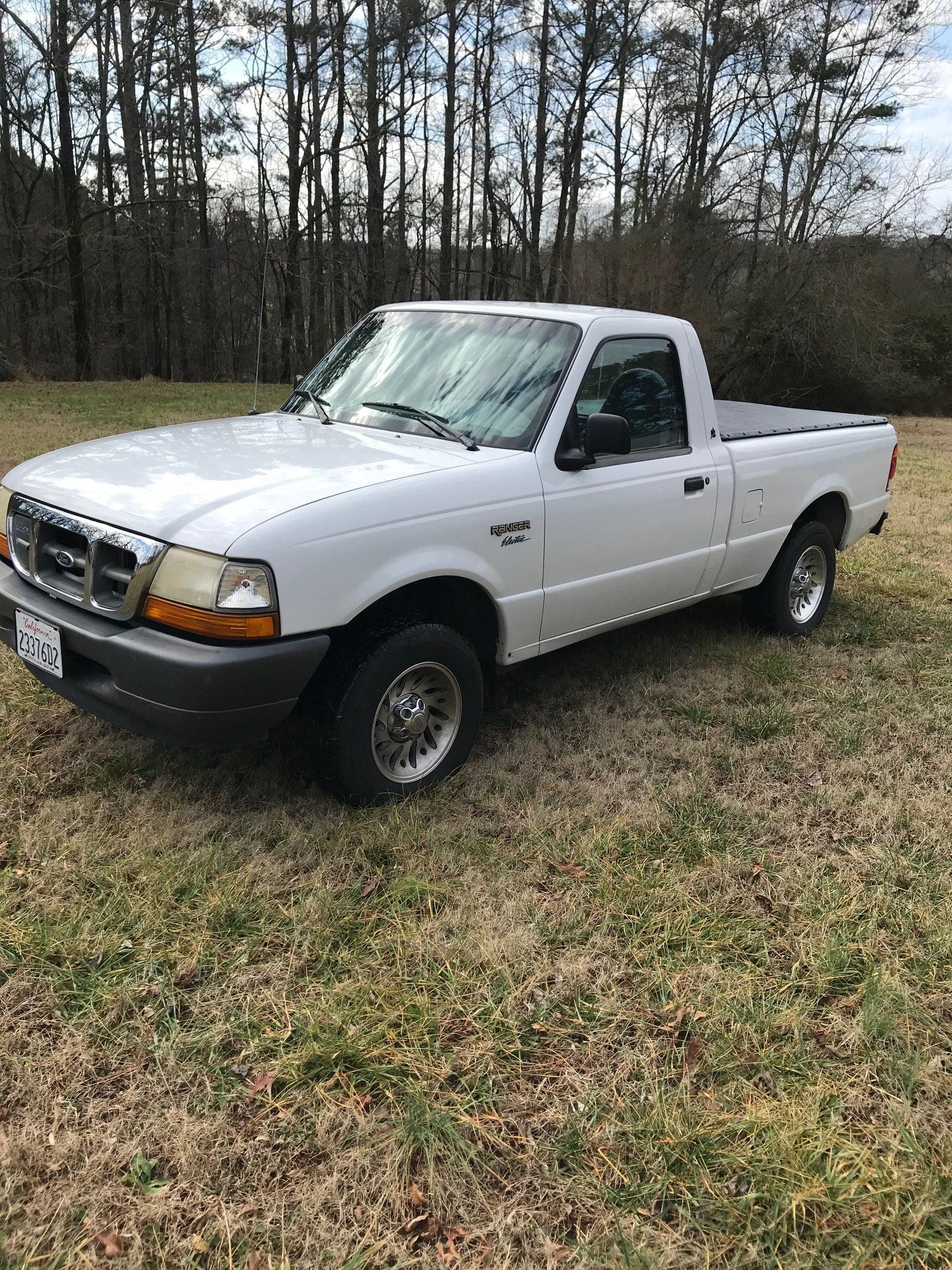 white ford ranger ev on grass in small field or clearing