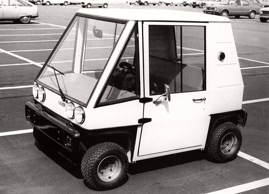 white Ligier JS4 city car in a parking lot during the 1980s