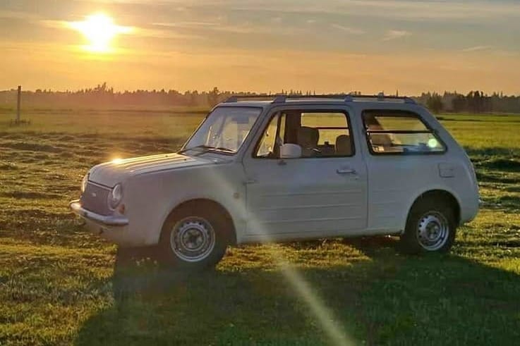 1991 Nissan pao car parked in a field