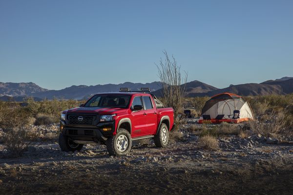 nissan frontier concept truck in red by desert campsite