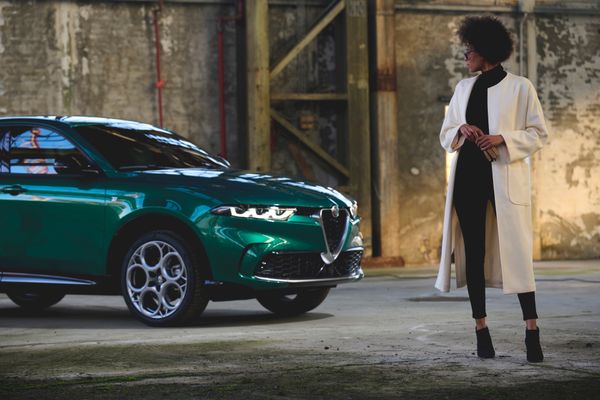 woman looking at alfa romeo tonale cuv